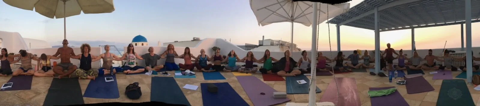 Group meditation at sunset