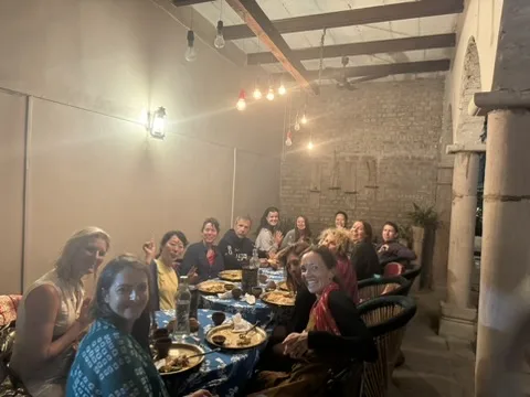 Communal dinner under string lights